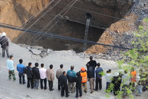 Road caves in, swallowing truck