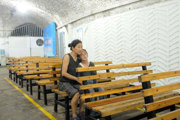 People cool off in air raid shelters