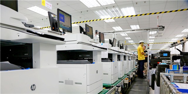 Hewlett Packard employees work on the production line in Weihai