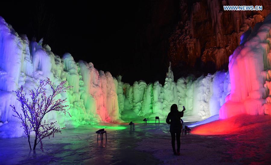 People visit frozen waterfall in N China