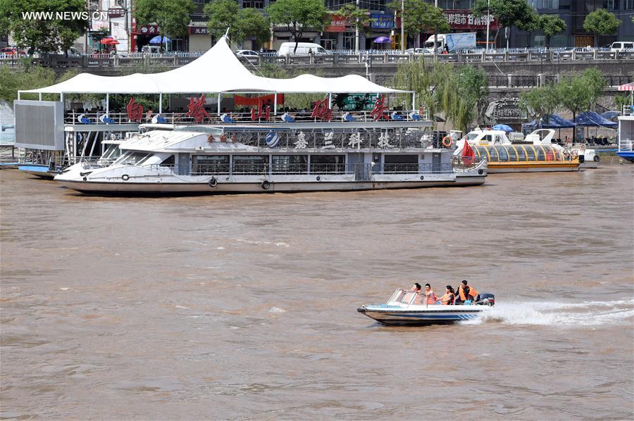 Tourists take sightseeing speedboat on Yellow River in China's Lanzhou