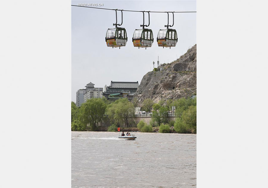 Tourists take sightseeing speedboat on Yellow River in China's Lanzhou