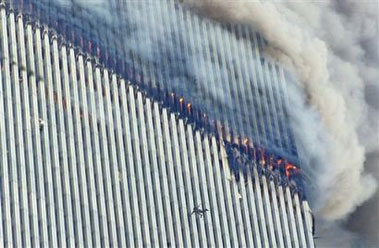 A person falls from the north tower of New York's World Trade Center as another clings to the outside, left center, while smoke and fire billow from the building, in this file photo of Tuesday Sept. 11, 2001.