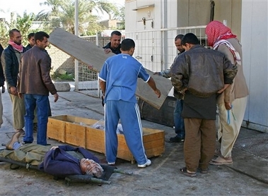 Iraqis prepare bodies for funerals outside the morgue in Baqouba, 60 kilometers (35 miles) northeast of Baghdad, Iraq, Thursday, Nov. 9, 2006. Iraqi police found five bullet riddled bodies in the suburb of Baqouba, provincial police said. (AP
