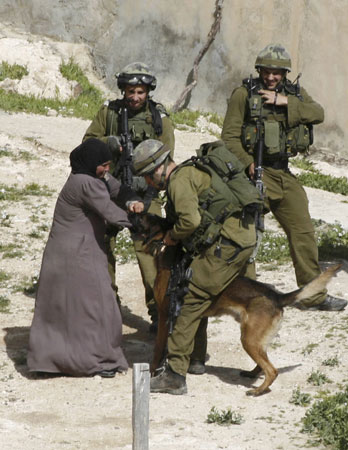 Israeli army dog attacks Palestinian woman