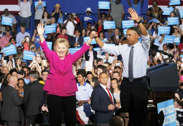 Obama hits campaign trail, says ready to 'pass baton' to Clinton