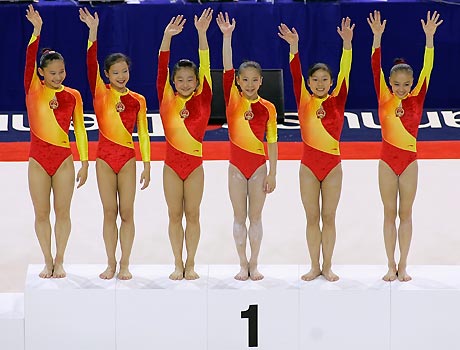 Gymnasts from China celebrate their gold medal win in the women's team final at the 39th Artistic Gymnastics World Championships in Aarhus, Denmark, October 18, 2006. Team China won the gold while the U.S. won the silver and Russia the bronze.