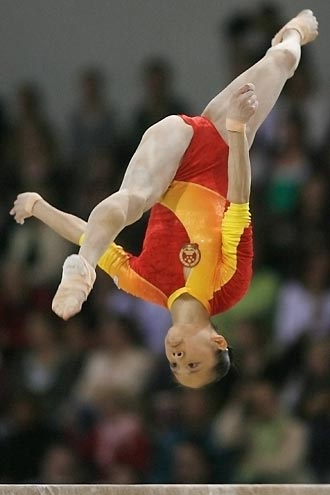 China's He Ning competes on the beam during the women's team final at the 39th Artistic Gymnastics World Championships in Aarhus, Denmark, October 18, 2006. 