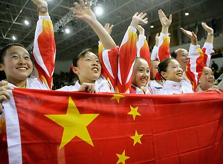 Gymnasts from China celebrate their gold medal win in the women's team final at the 39th Artistic Gymnastics World Championships in Aarhus, Denmark, October 18, 2006. Team China won the gold while the U.S. won the silver and Russia the bronze.