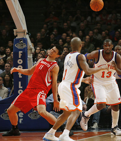 Houston Rockets center Yao Ming (11) reacts after his pass went to New York Knicks guard Steve Francis (1) in the first half of their NBA basketball game in New York, November 20, 2006. Knicks center Jerome James watches the play .