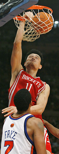 New York Knicks forward Channing Frye (7) watches Houston Rockets center Yao Ming (11) stuff the ball in the fourth period of their NBA basketball game in New York, November 20, 2006. Yao had 26 points in the Rockets 97-90 win. 