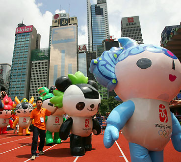 Five Friendlies, mascots of the 2008 Beijing's Olympic Games, walk on a street during a parade celebrating Youth Day, which marks the history of the May 4 movement, a revolution against feudalism launched by Chinese young people in 1919, in Hong Kong May 7, 2006. The mascots of 2008 Beijing's Olympic Games are called (from R) Beibei, Jingjing, Nini, Yingying and Huanhuan. 