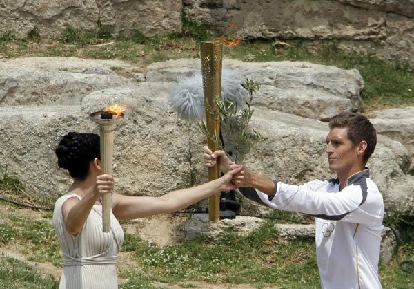 London Olympics flame lit in Olympia, torch relay begins