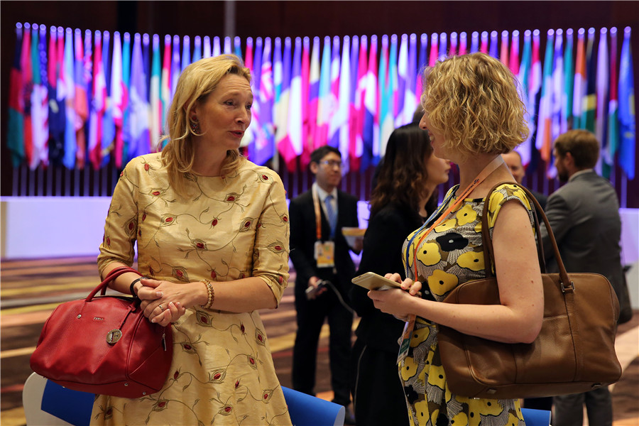 Exhibitors at the Beijing Fair share a light moment