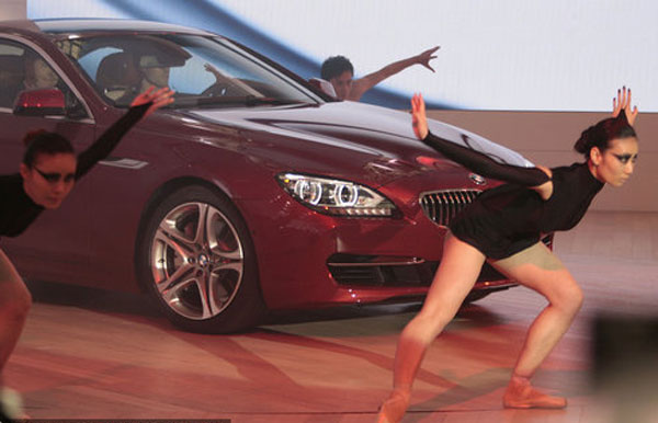 Dancers perform next to a BMW car