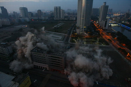 Buildings fall with blast demolition