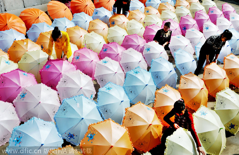 Women make umbrellas for export in Jiangxi