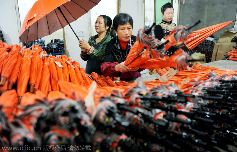 Women make umbrellas for export in Jiangxi