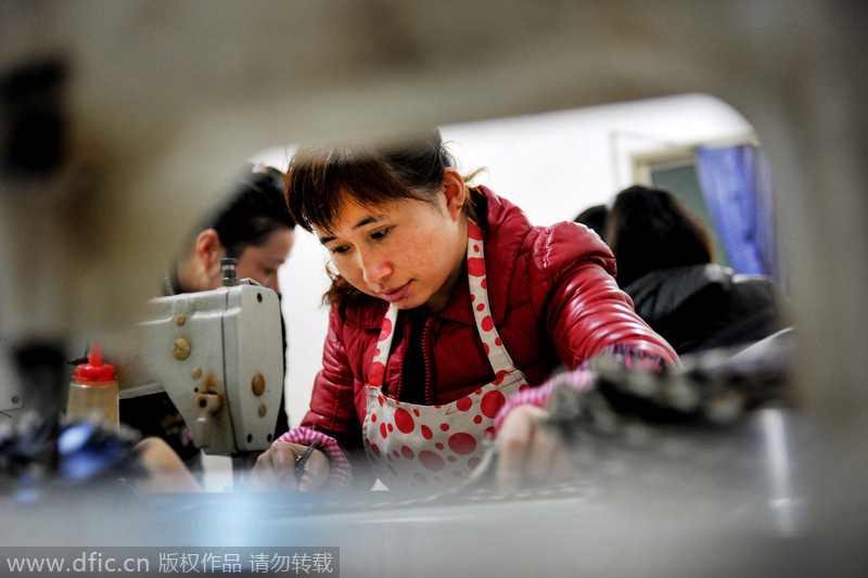 Women make umbrellas for export in Jiangxi