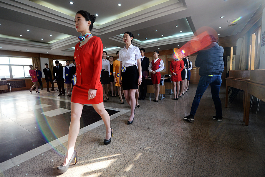 Candidates do squats, sing and dance to become train attendants