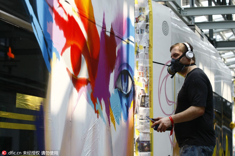 Chinese and foreign graffiti artists decorate trolley in Guangzhou