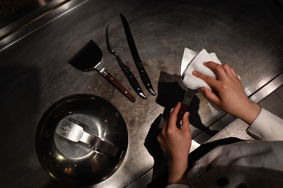 Young female chef performs for five-star hotel guests