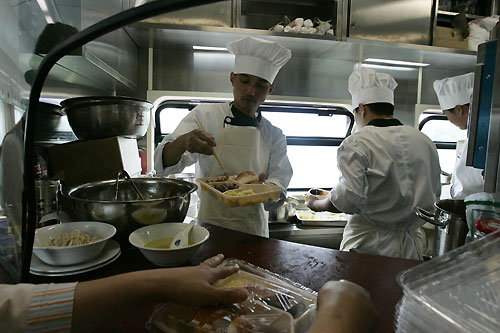 Cooks prepare breakfast on board the first Beijing-to-Lhasa train as it passes Xian July 2, 2006. The 4,000-km (2,500-mile) journey will reach altitudes of over 5,000 metres (16,400 feet) on the Tibetan plateau.