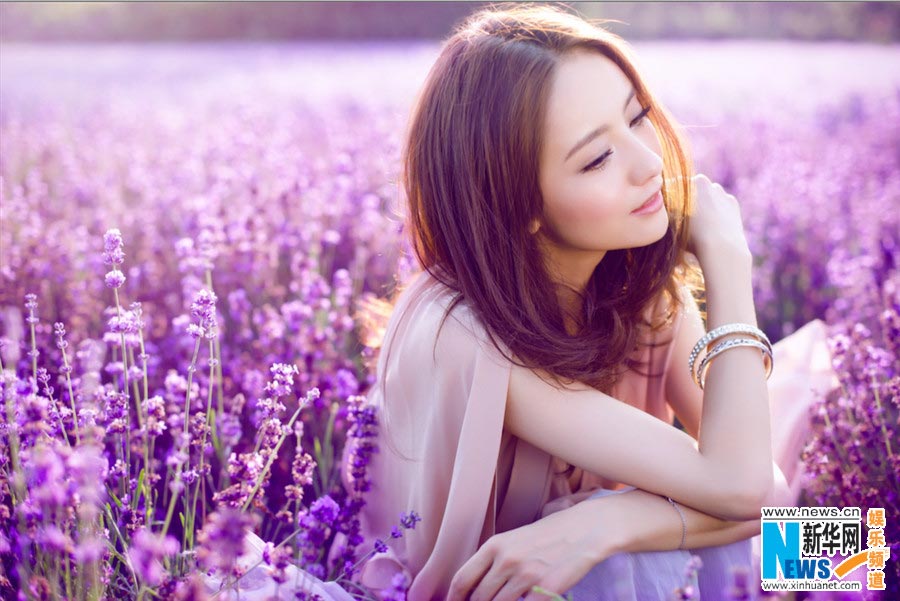 Tong Liya poses in blooming lavender flowers