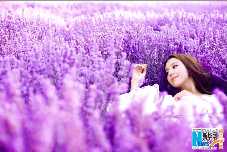 Tong Liya poses in blooming lavender flowers