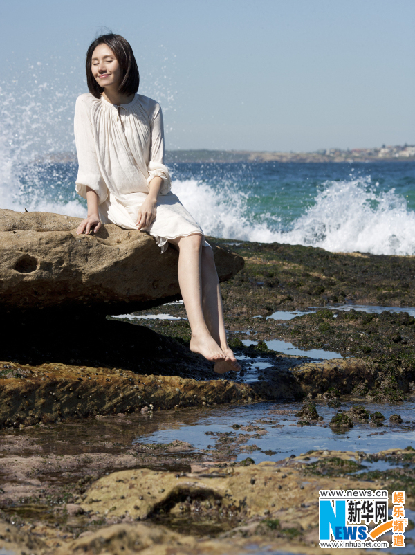 Actress Yuan Quan poses on beach