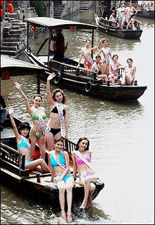 A group of contestants for Miss China/Tourism 2006 pose on boats along canals in Xitang, 06 April 2006. This year is expected to mark a turning point in the worldwide tourism industry following the post-September 11 slump, especially as China emerges as a lucrative new source of tourists ready to travel the globe(AFP