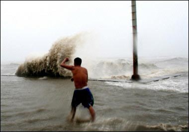 Strong waves break over the sea walls at the fishport of Bulan town, in Sorsogon province. The Philippines death toll from Typhoon Chanchu has risen to at least 41 as the storm continued its destructive path across the region.(AFP