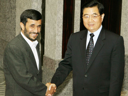 Iran's President Mahmoud Ahmadinejad (L) meets China's President Hu Jintao before their bilateral meeting at the Xijiao State Guest House in Shanghai June 16, 2006.