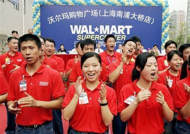 Workers perform the warm-up dance during the opening ceremony of the newly opened Wal-Mart store in Shanghai in this July 28, 2005 file photo. Wal-Mart Stores Inc. said Thursday, Aug. 10, 2006 it has agreed to cooperate with China's state-sanctioned labor group in creating unions at its 60 Chinese outlets. (AP