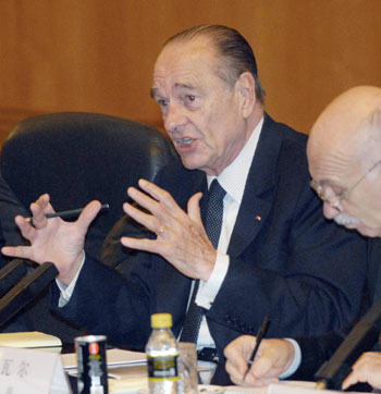 France's President Jacques Chirac (L) speaks during a meeting with Chinese President Hu Jintao (not pictured) at the Great Hall of the People in Beijing October 26, 2006. 