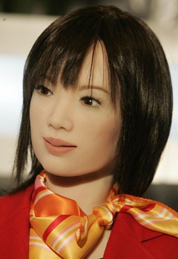 Humanoid robot 'Actroid DER' watches during a media preview of the Asia Robot Dream Exhibition at a shopping centre in Hong Kong November 24, 2006. [Reuters]