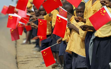 Liberian children hold Chinese flags before the arrival of China's President Hu Jintao in Monrovia February 1, 2007. 