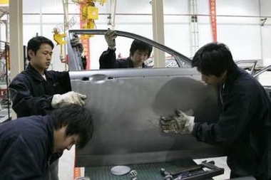 Technicians work at the production line for MG cars of Nanjing Automobile Group in Nanjing, east China's Jiangsu province March 26, 2007. Nanjing Automobile Group, who took over MG Rover in 2005, said production in China of cars based on MG Rover technology will begin in March. 