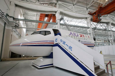 A full scale model of the first Chinese developed commercial jet, the ARJ-21, is seen at Shanghai's Aircraft Manufacturing factory March 30, 2007. The regional jet, called the ARJ-21, will seat 70 to 100 people. The plane's components have been produced at plants nationwide and taken to Shanghai for final assembly. The first test flight of the prototype plane will be March 2008.