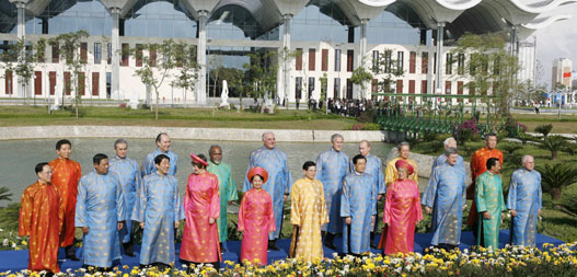 Leaders attending the Asia-Pacific Economic Cooperation (APEC) summit pose for a family photo wearing traditional Vietnamese clothes, known as the 