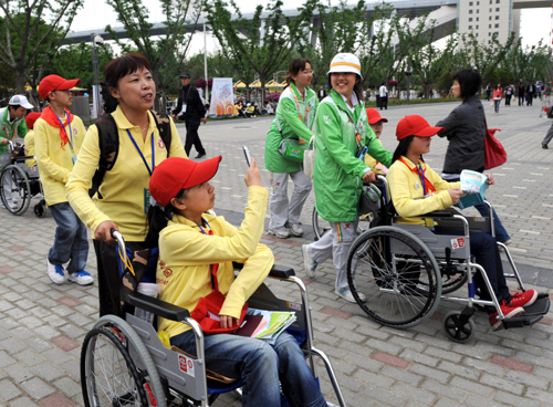 Disabled quake children visit Expo Site