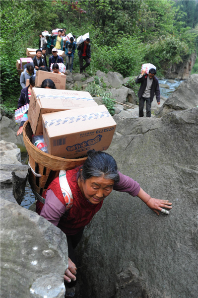 Villagers climb mountains to get relief supplies