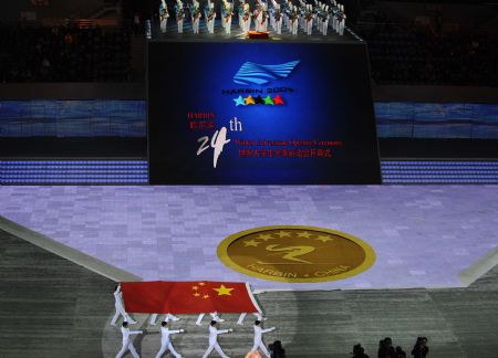 Chinese national flag is escorted into Harbin International Conference, Exhibition and Sports Centre Gym at the opening ceremony of the 24th World Winter Universiade in Harbin, capital of northeast China&apos;s Heilongjiang Province, Feb.18, 2009. (Xinhua/Guo Dayue
