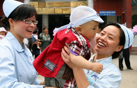 Quake babies reunite with nurse rescuers one year on