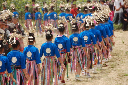 Miao people perform traditional group dance 