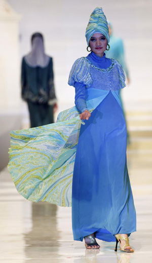 Models present creations by Malaysian designer