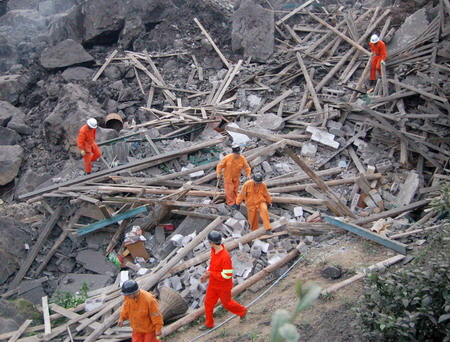 Landslide rescuers find 2 more bodies; 63 still missing