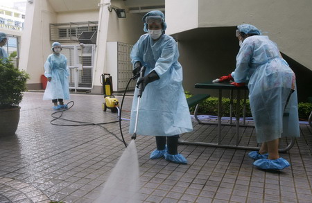 Health officers disinfect school in Hong Kong