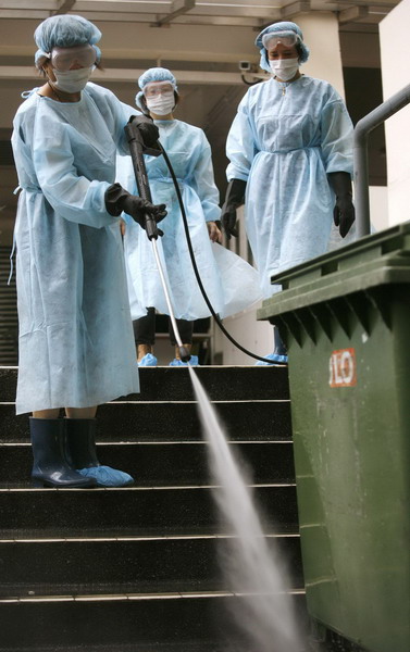 Health officers disinfect school in Hong Kong