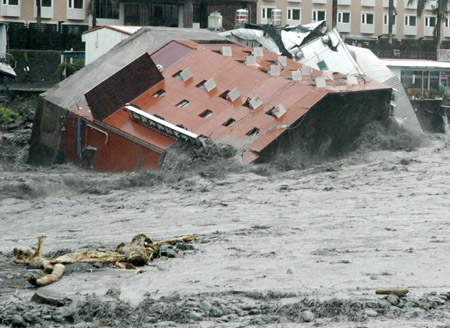 Hotel swept into river after typhoon